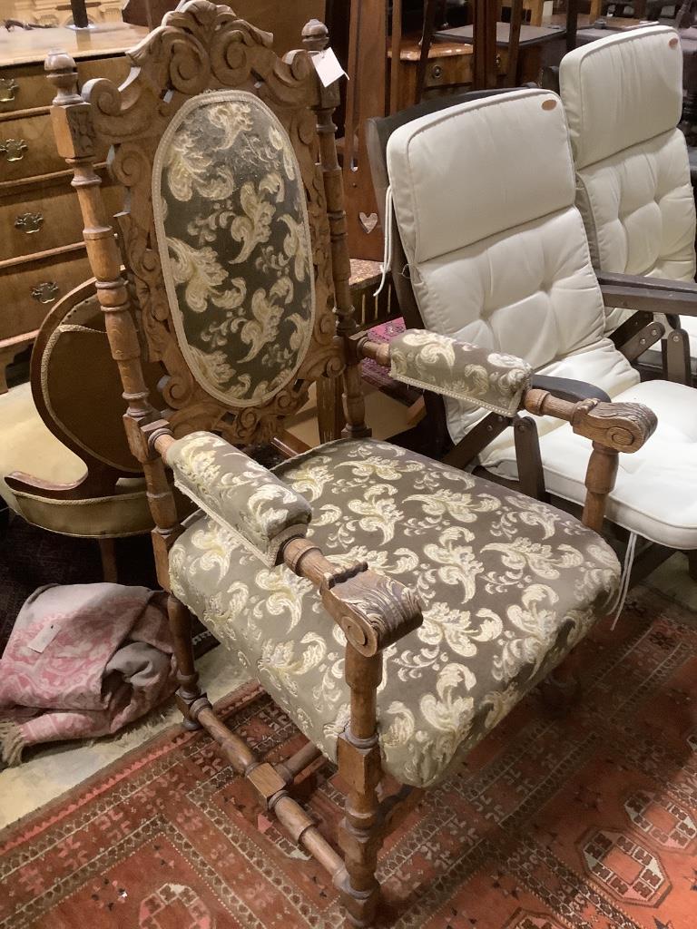 A Victorian mahogany buttonback nursing chair and a carved oak armchair